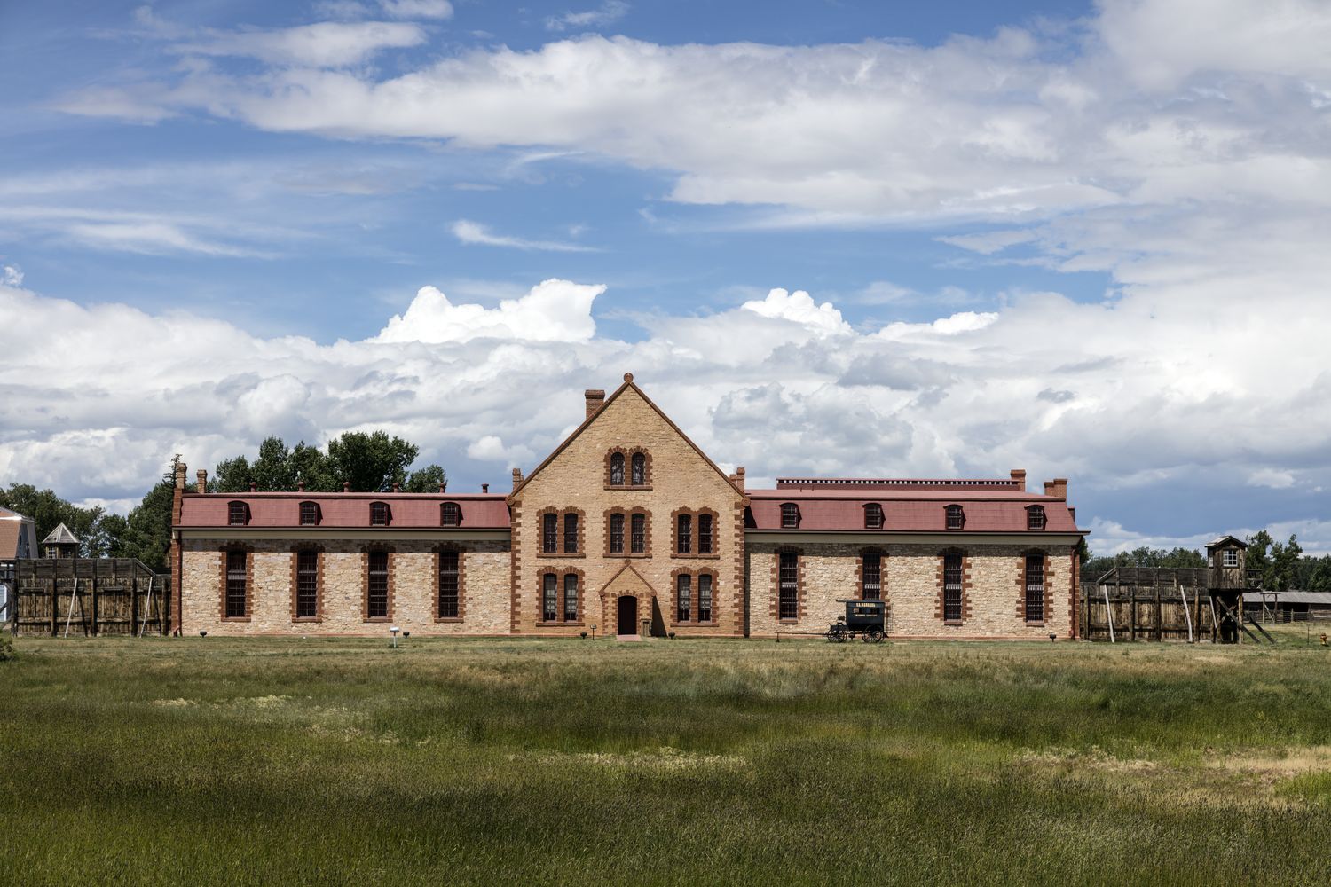 The stone front of the Wyoming Territorial Prison under a blue sky.